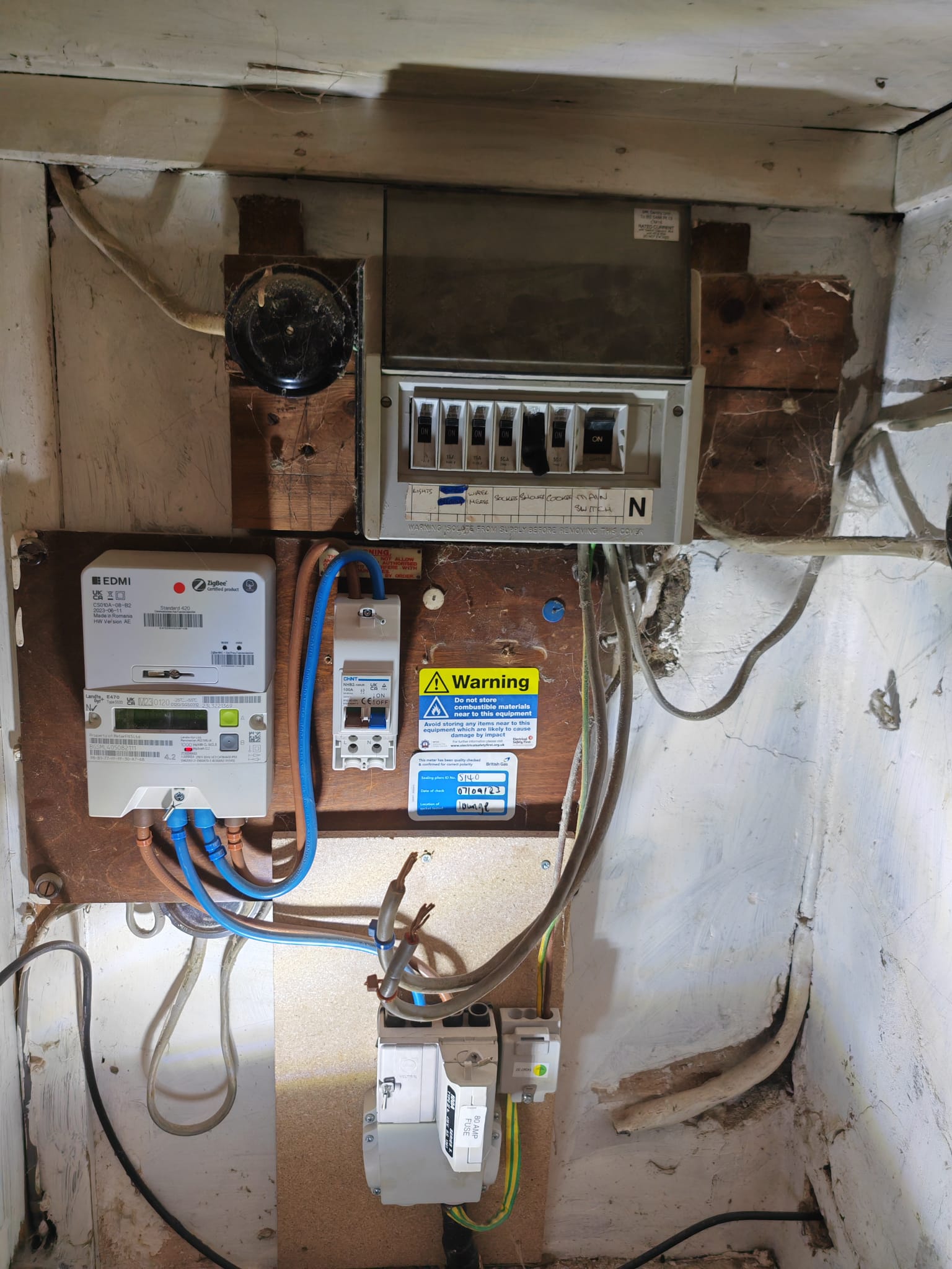 Old wooden-backed fuse board with rewireable fuses, prior to upgrade