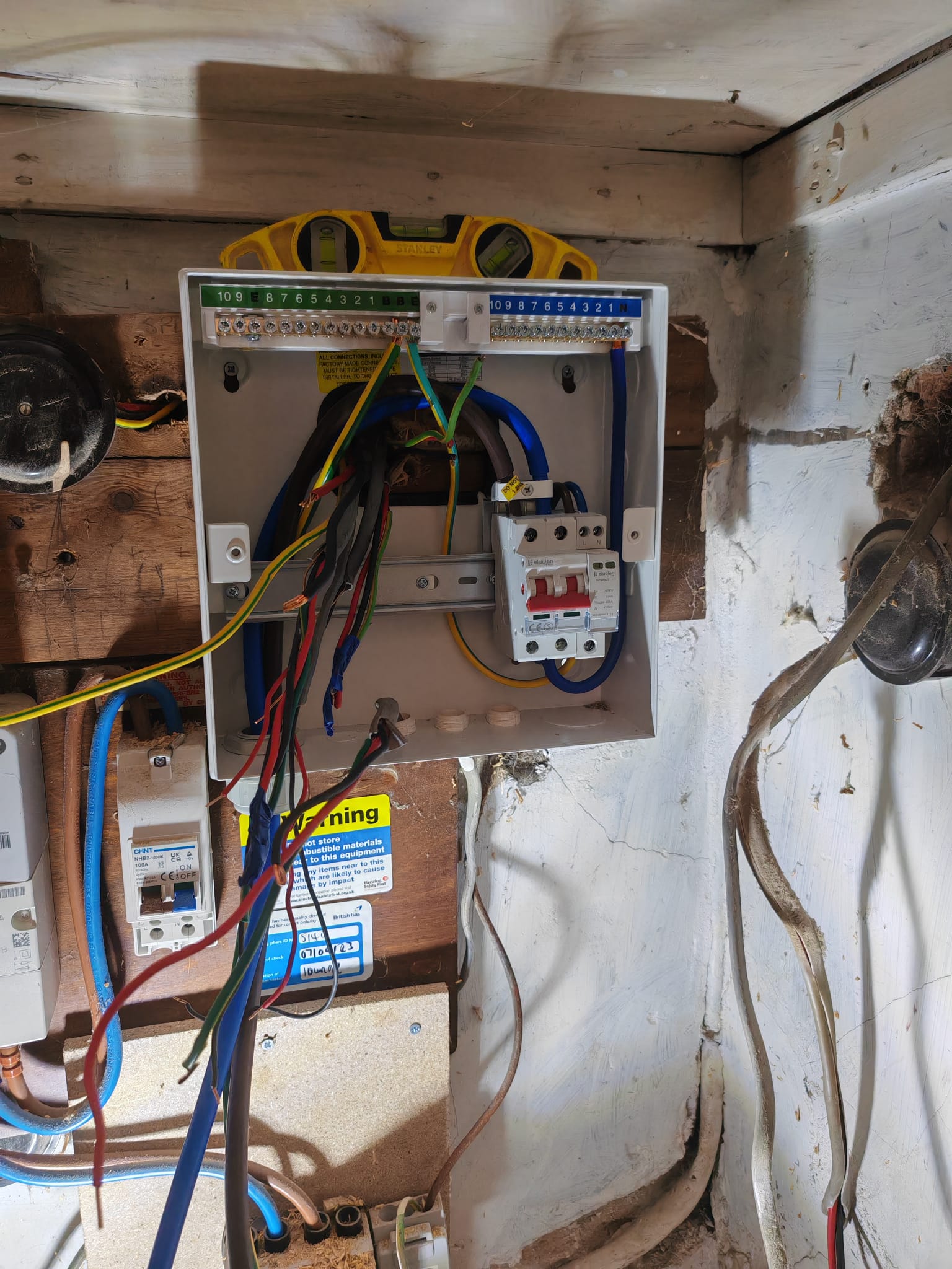 Electrician wiring circuits into a new consumer unit
