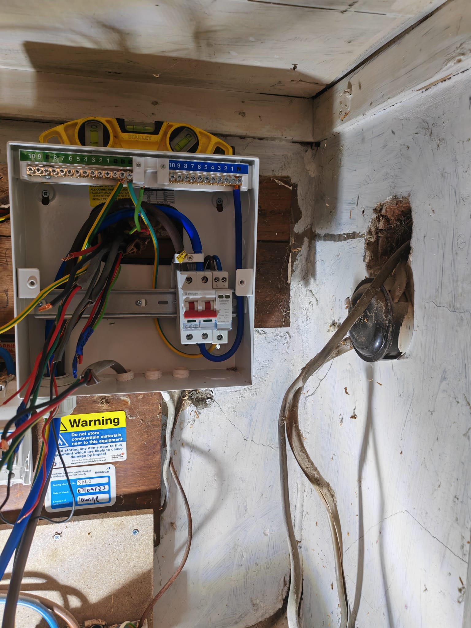Close-up of consumer unit RCBOs with red, blue and brown cables connected