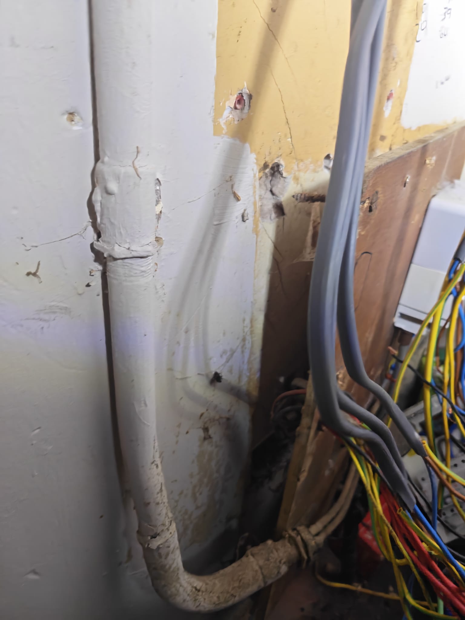 Cable routed through the wall to the new consumer unit position