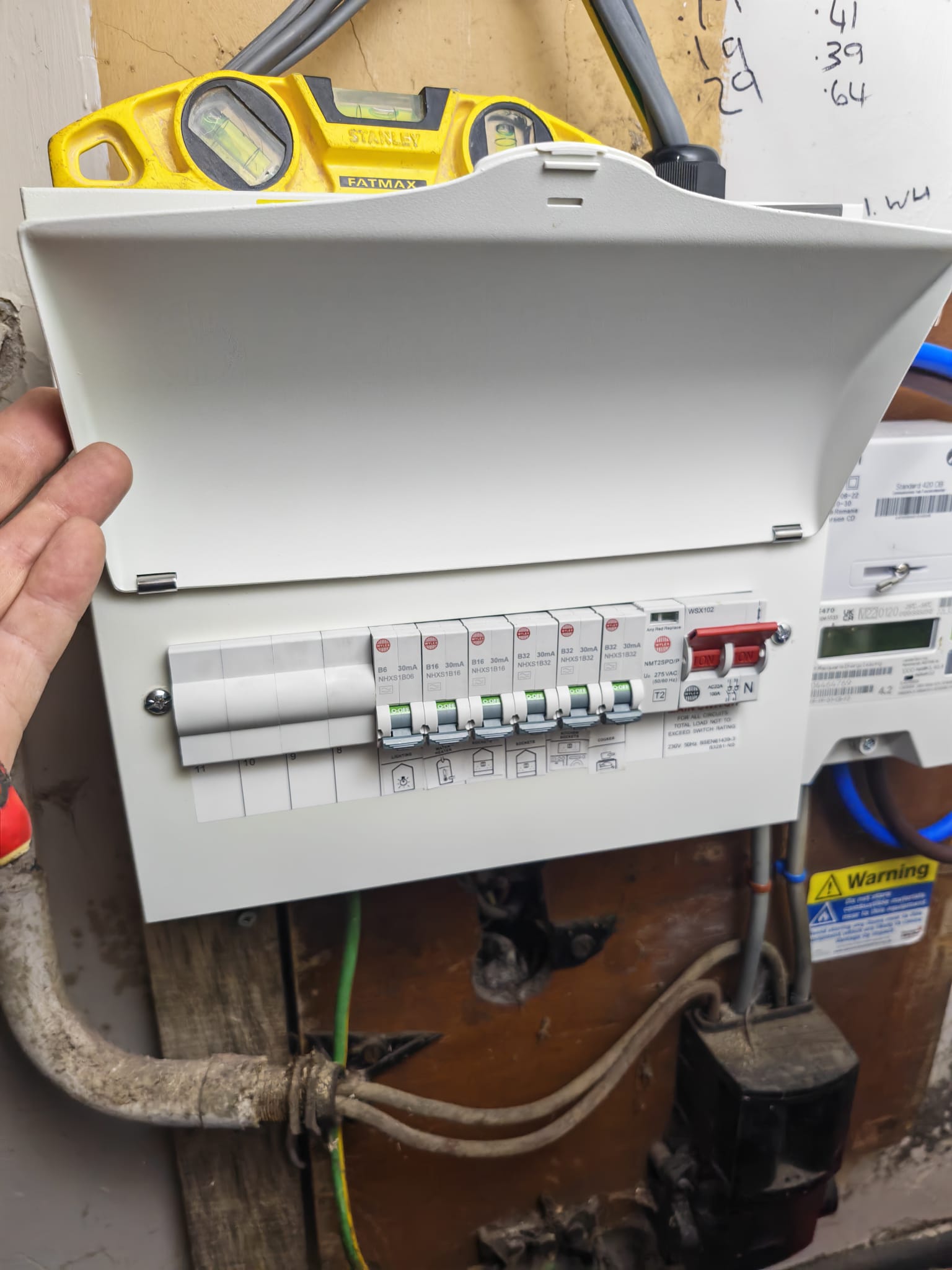 Finished Wylex consumer unit shown open with circuits wired and labelled