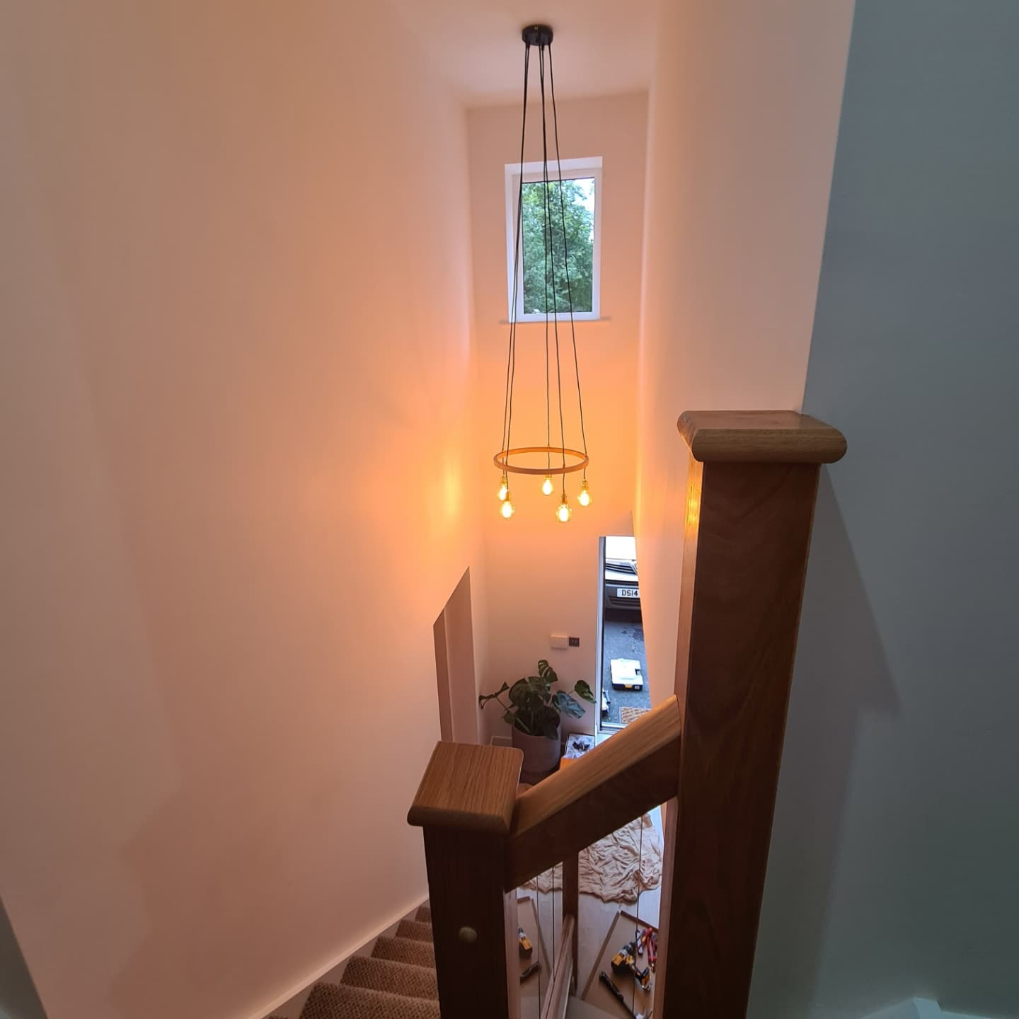 Chandelier light fitting installation — completed stairwell